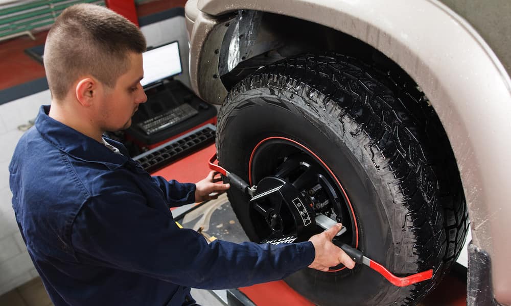 RDI Power auto technician works on a diesel truck's wheel alignment