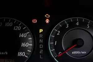 The warning lights of car engine check, door opened, parked and hand break in the speedometer of a vehicle
