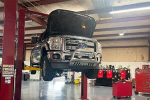 Suspended Ford pick-up truck at RDI Powers. Concept image of “Truck Transmission Talk: Examining the Ford E40D and 4R100” | RDI Powers in Brooksville, FL.