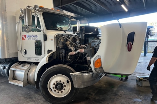 Heavy duty diesel truck maintenance and repair near me in Brooksville, FL with RDI Power specializing in Peterbuilt, Mack, International, Western Star, Volvo and more. Image of Builders FirstSource heavy duty peterbuilt fleet truck that came into the shop with hood open for maintenance services.