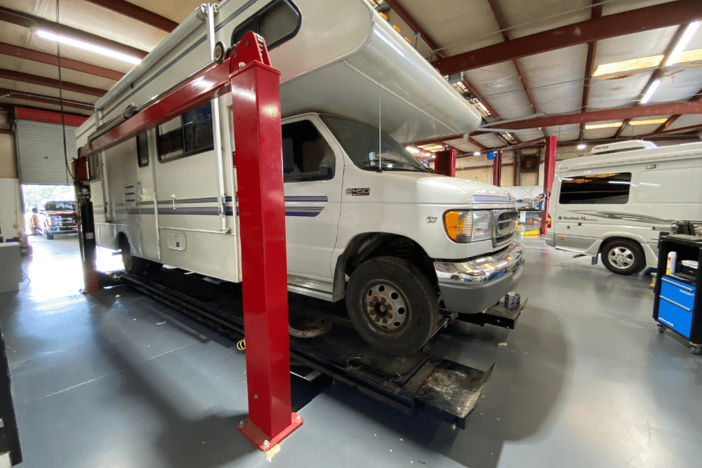 RV Fuel Line, diesel repair in Brooksville, FL at RDI Power. RV lifted inside a well-equipped service bay, highlighting professional RV repair and maintenance capabilities in a clean, organized shop.