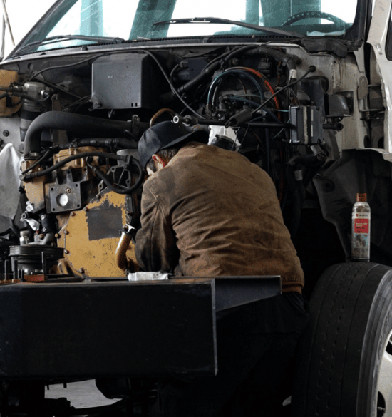 Diesel Truck Tuning by RDI Power in Brooksville, FL. A mechanic inspecting a diesel engine during routine maintenance